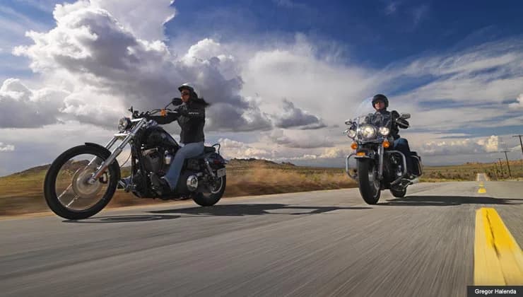 Couple riding a motorcycle on an open road